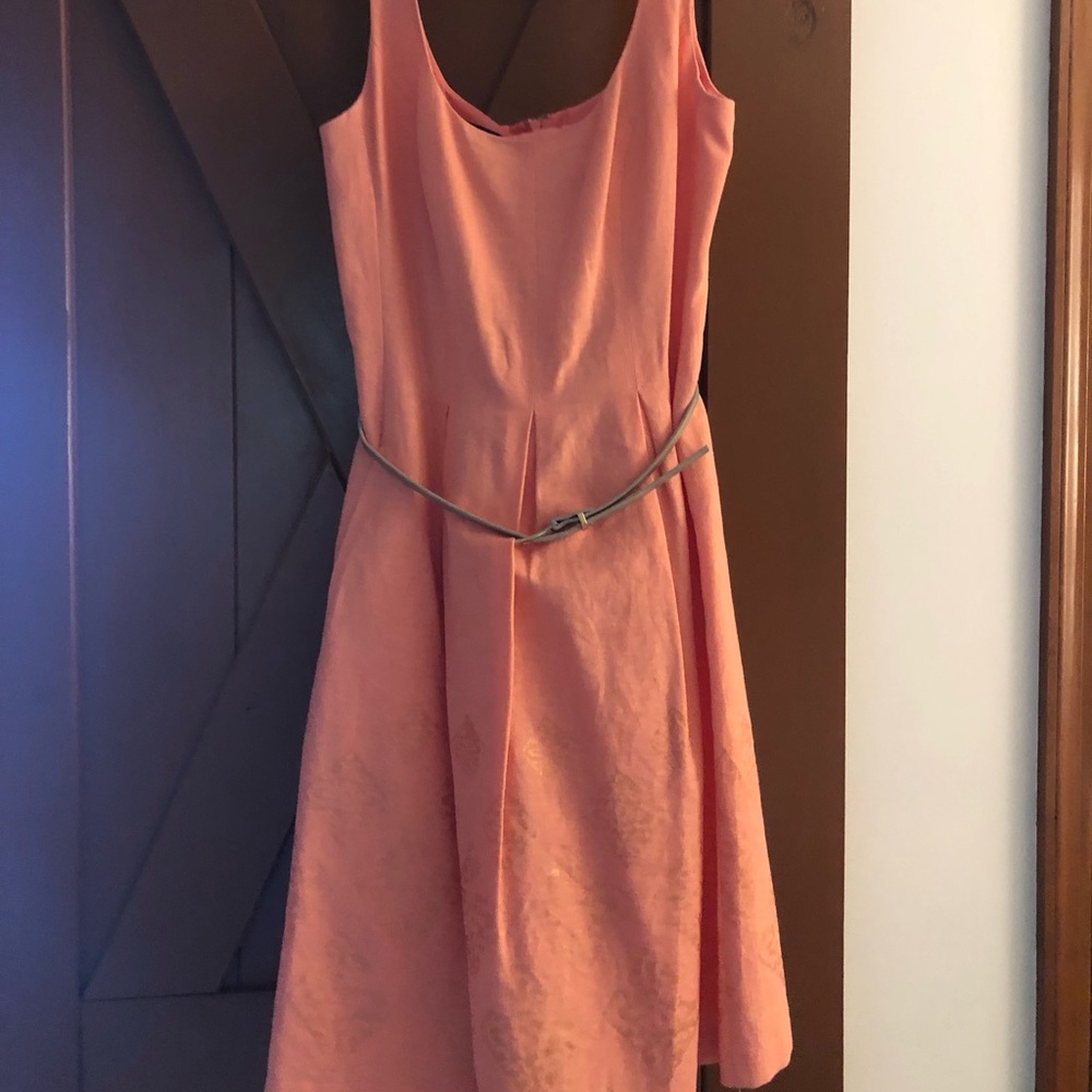 Women’s peach colored belted tank dress.